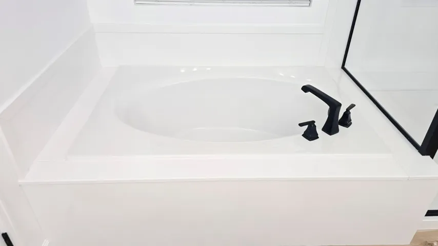 Built-in soaking tub with matte black fixtures
