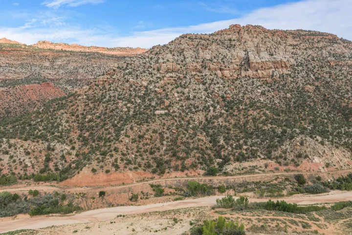 Expansive natural landscape featuring rolling hills and varied rock formations