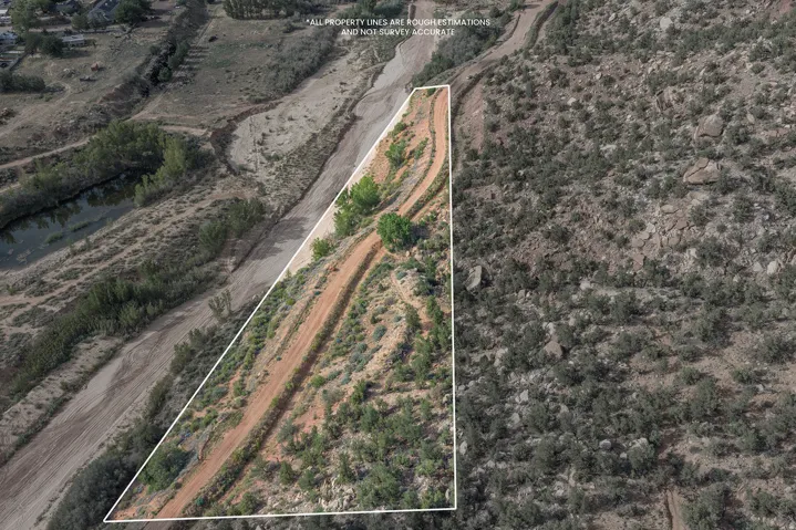 Expansive land parcel with natural terrain and bordering a water feature