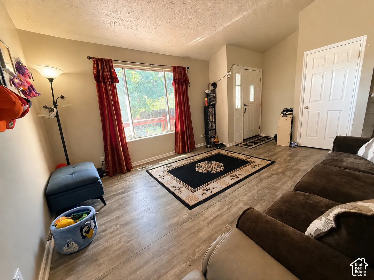 Vaulted ceilings, wood-finish flooring, and a multi-pane entry door