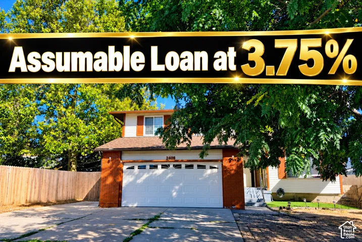 Two-story residence featuring a brick and siding exterior, two-car garage, concrete driveway, and wooden perimeter fencing