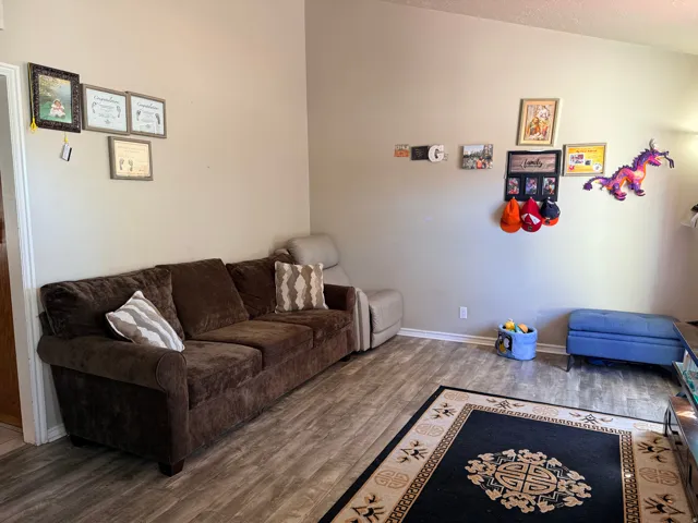 Wood-finish flooring with light-toned walls and white trim