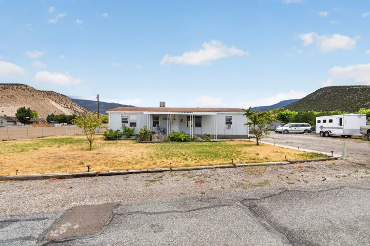 Single-story residence with a covered front porch and a gravel driveway