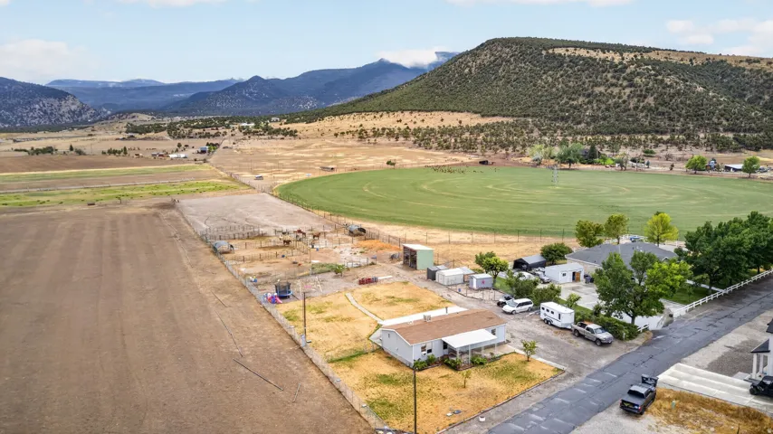 Expansive agricultural fields, circular irrigated crop land, and mountainous terrain