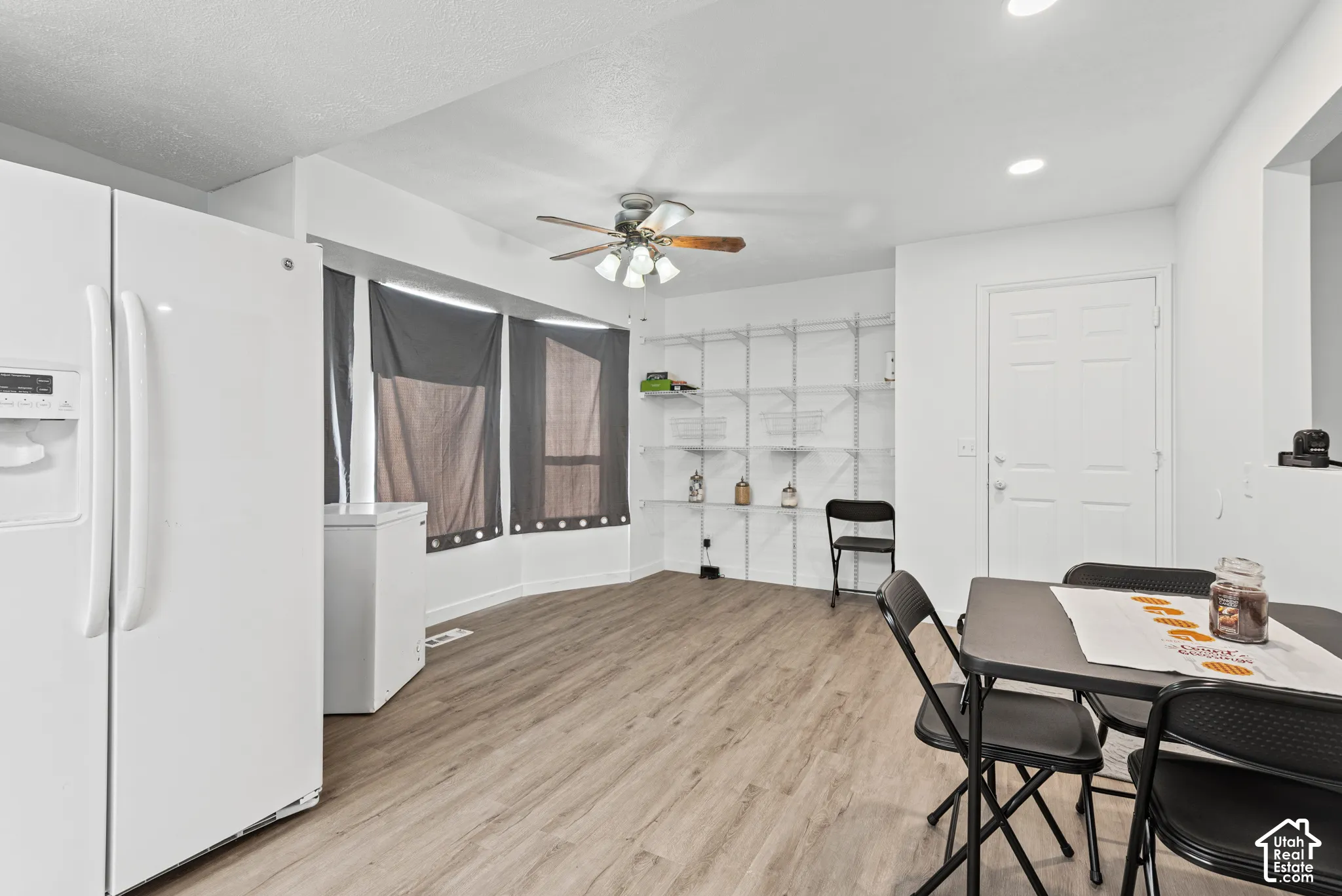 Wood-finish flooring, recessed lighting, and a ceiling fan with light kit