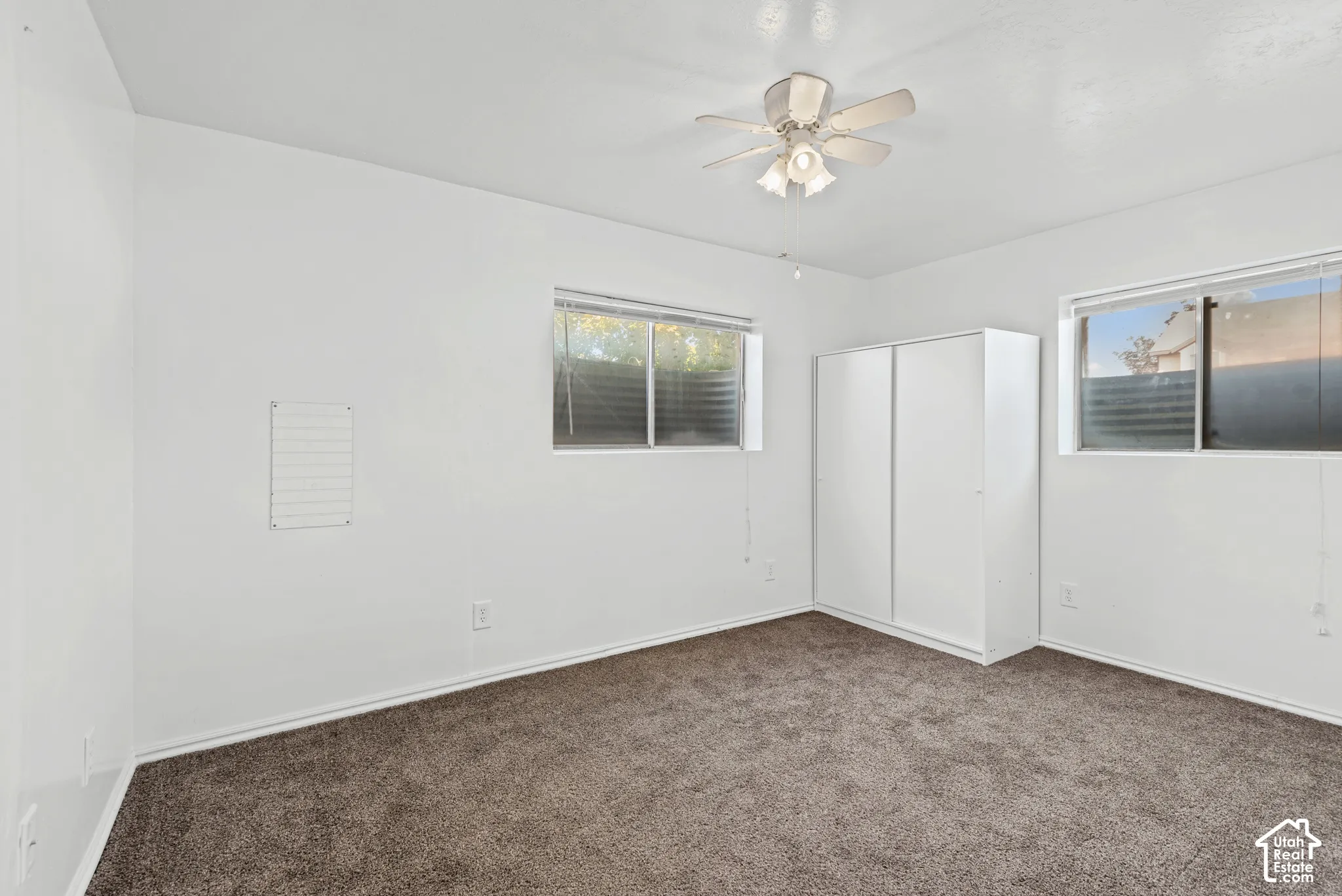 Recessed lighting, ceiling fan, two windows, wall-to-wall carpeting
