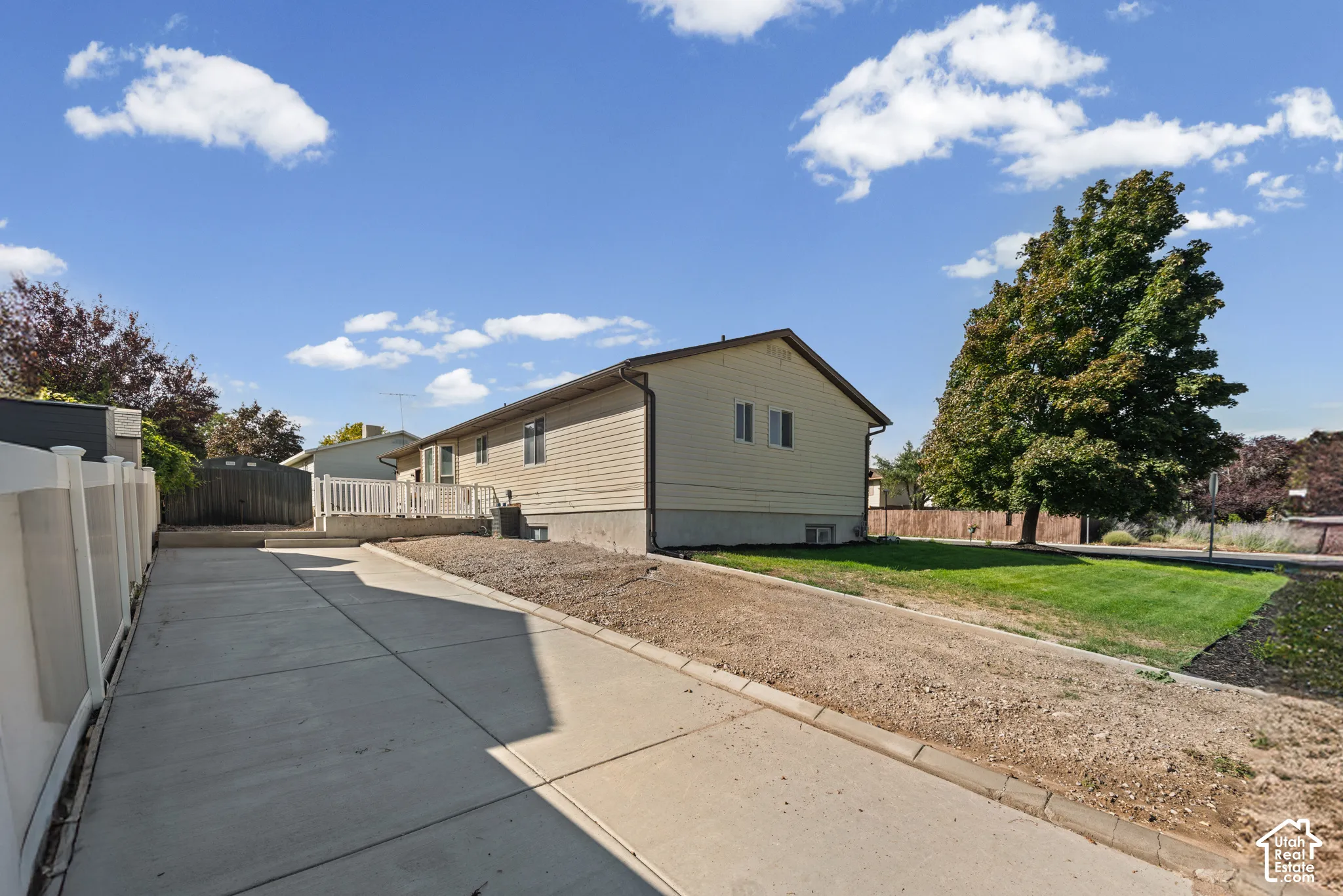 Concrete driveway with white panel fencing