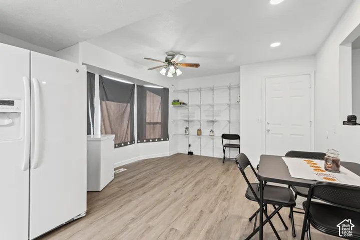 Wood-finish flooring, recessed lighting, and a ceiling fan with light kit