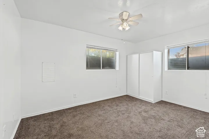Recessed lighting, ceiling fan, two windows, wall-to-wall carpeting