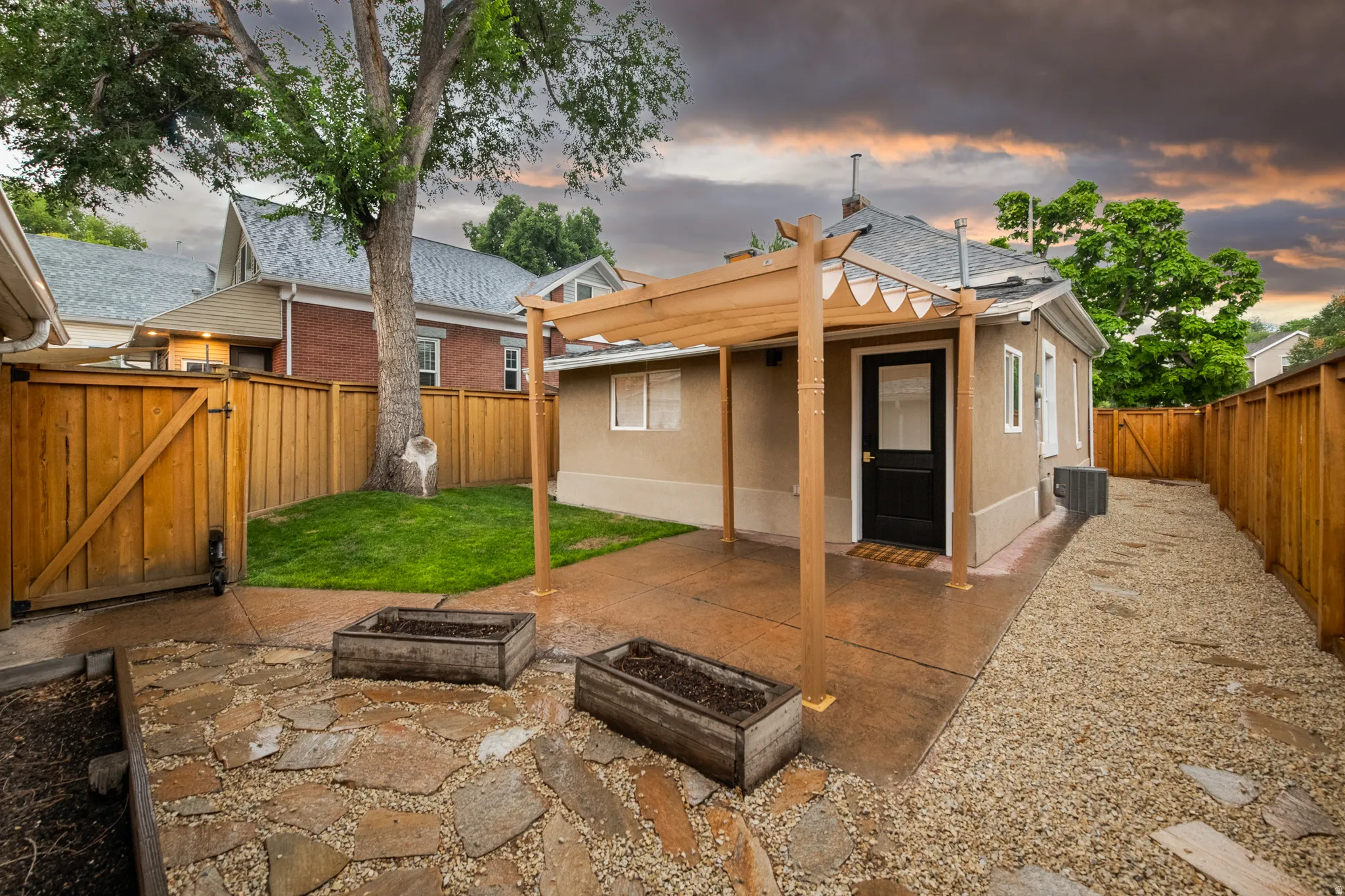 Private backyard featuring a wood pergola, wood privacy fence, and a flagstone patio