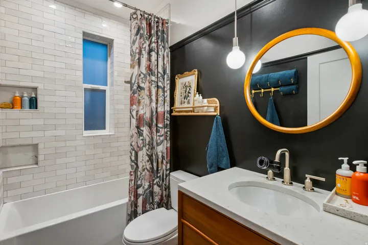 Built-in bathtub with subway tile surround and recessed shelving