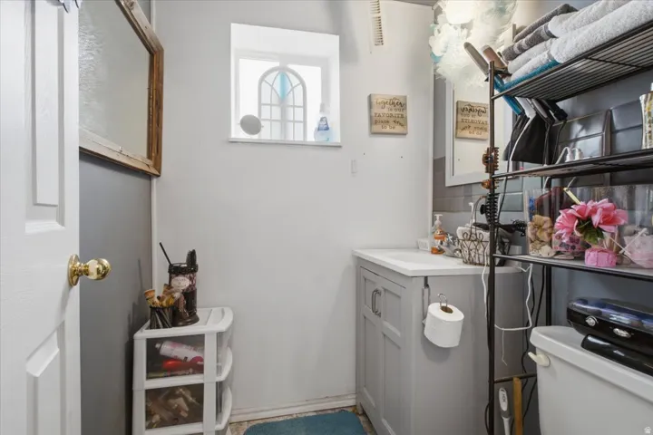 White vanity with an integrated sink and gray cabinet doors, complemented by a subway tile backsplash