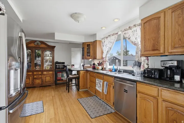 Wood-finish flooring throughout, with natural wood cabinetry and dark countertops