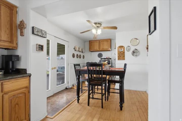 Wood-finish flooring throughout, with a ceiling fan featuring integrated lighting