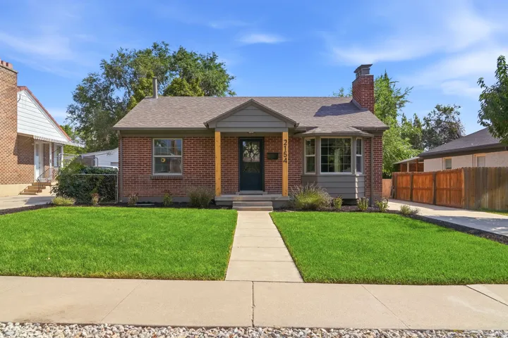 Red brick exterior with a grey gable accent and a bay window