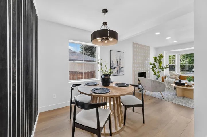 Recessed lighting, wood-finish flooring, a decorative fireplace, and a bay window