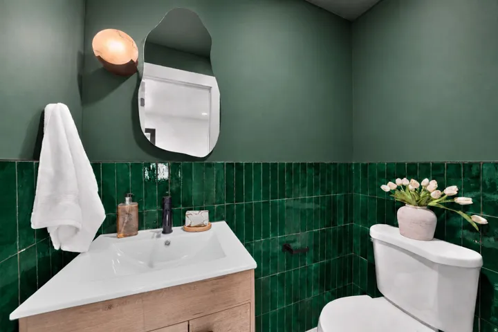 Modern vanity with integrated sink, natural wood-finish cabinetry, and matte black faucet