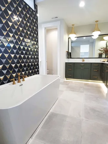 Freestanding soaking tub with a wall-mounted accent tile feature
