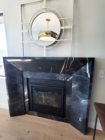 Black stone-finish fireplace with integrated firebox