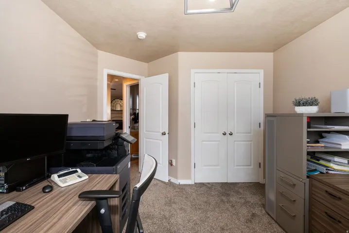 Neutral wall paint, textured ceiling, carpeted flooring, and white interior doors
