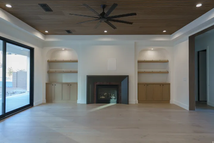 Wood-finish ceiling with recessed lighting and a ceiling fan