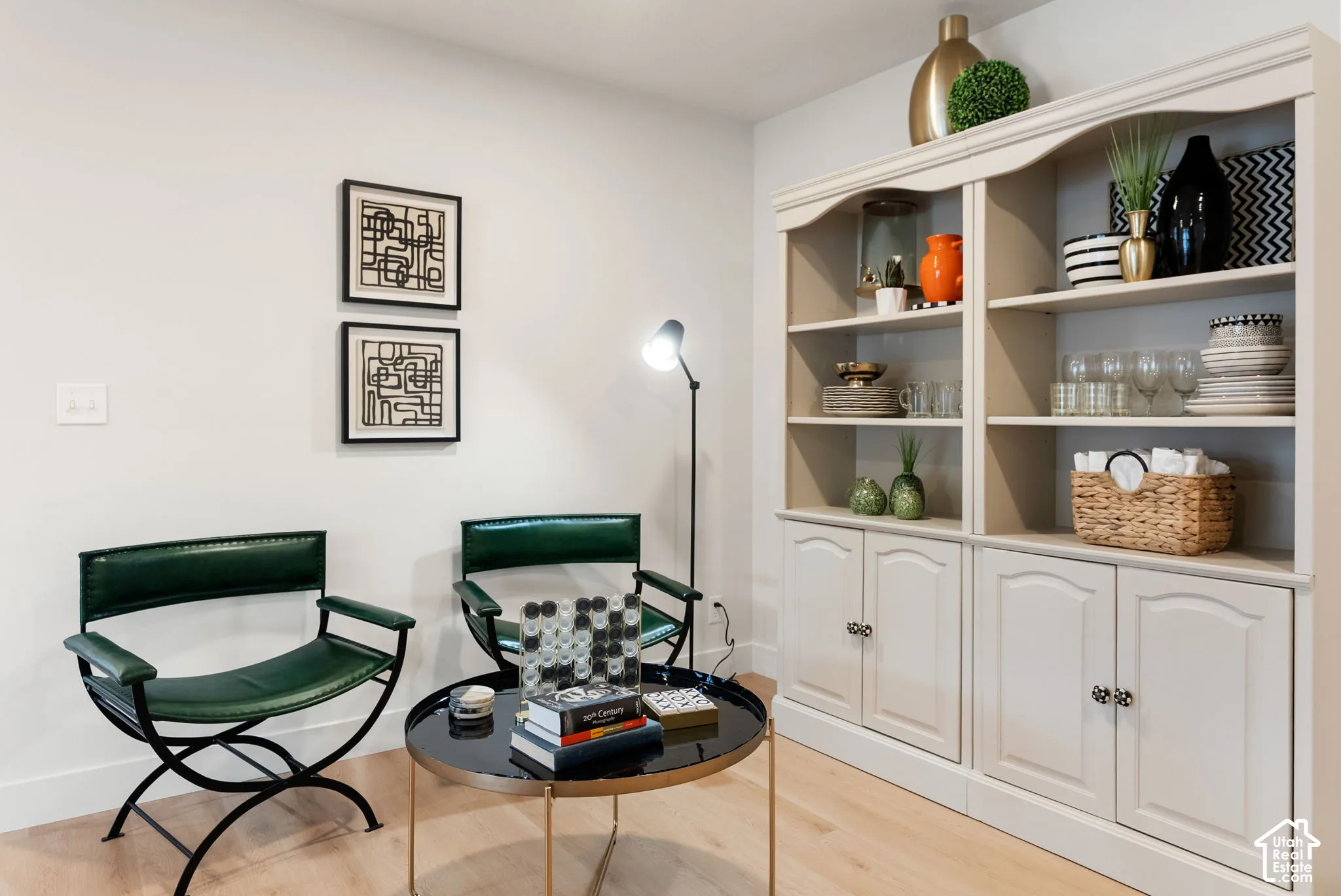 Built-in shelving unit with lower cabinetry, light wood-finish flooring, and light-toned walls