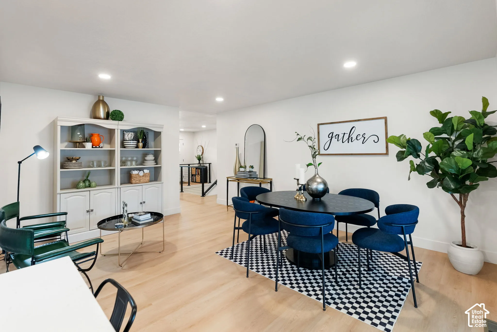 Recessed lighting, light wood-finish flooring, built-in shelving, and white wall finishes