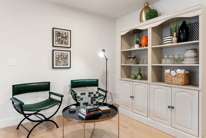 Built-in shelving unit with lower cabinetry, light wood-finish flooring, and light-toned walls