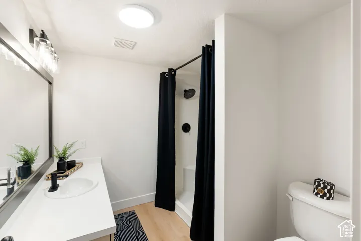 Bathroom with a single vanity, undermount sink, black faucet, and a large mirror
