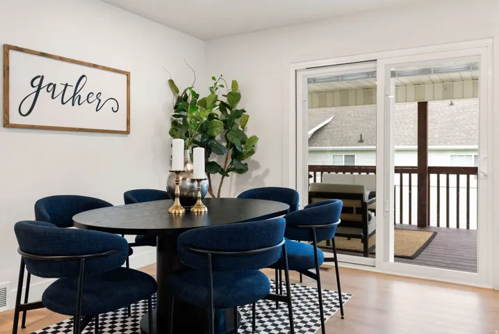 Wood-finish flooring with white walls and a large sliding glass door