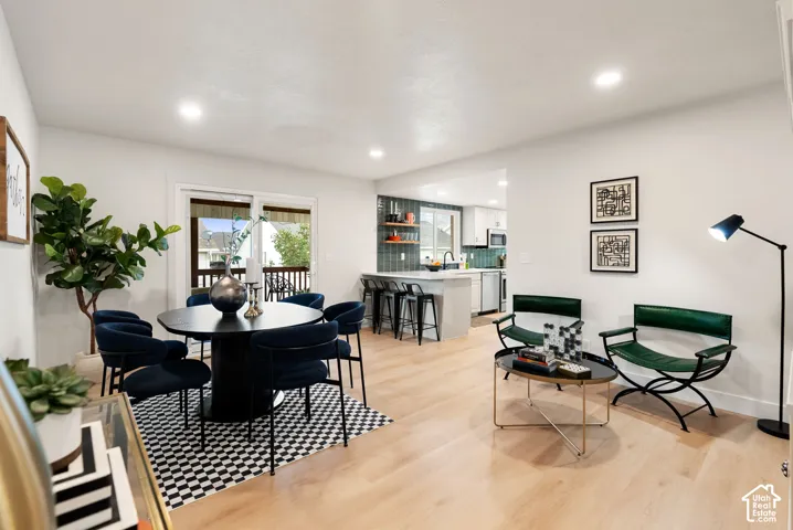 Open-concept living space with light wood-finish flooring