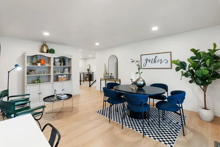 Recessed lighting, light wood-finish flooring, built-in shelving, and white wall finishes