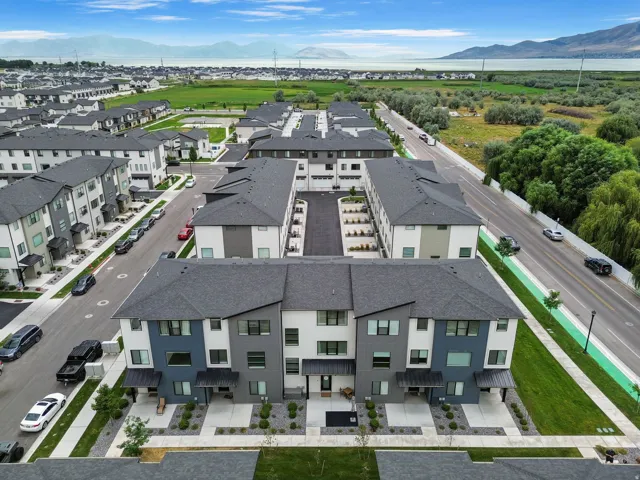 Modern multi-story townhomes with varied facade colors and dark shingle roofs