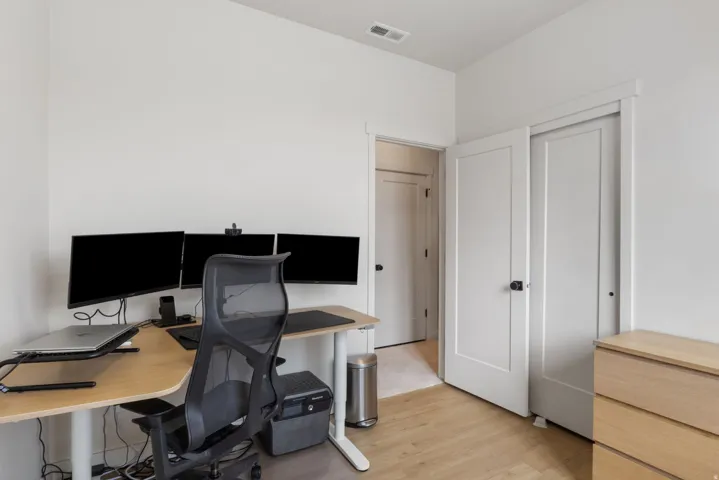 Recessed lighting, wood-finish flooring, white walls, and white trim