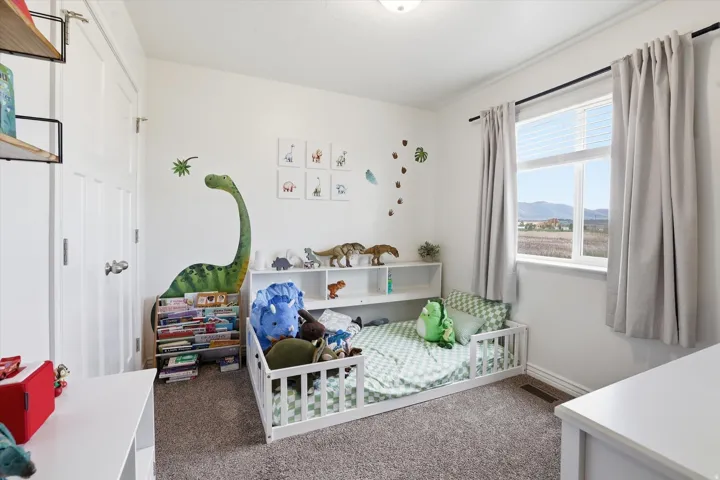 Recessed lighting fixture, plush carpet flooring, and a large window with white blinds