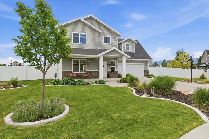 Two-story residence with a covered front porch and stone accents