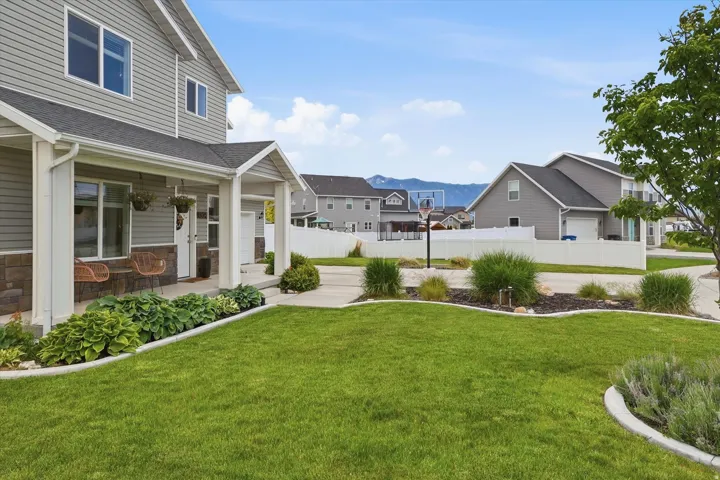 Exterior with gray siding, stone accents, and a covered porch
