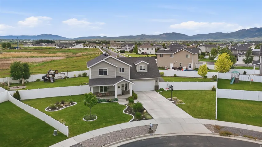 Two-story residence with a gray exterior, white trim, and a two-car garage