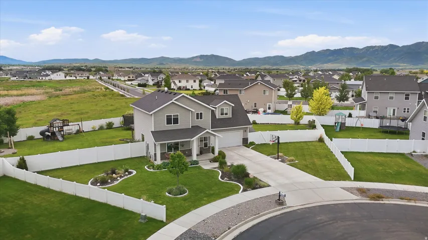 Two-story residence featuring light gray siding with dark trim accents and a covered front porch