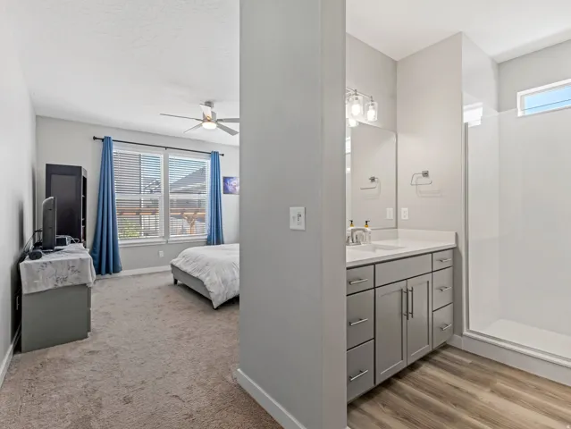 Contemporary bathroom vanity with a white countertop, undermount sink, and silver-tone hardware
