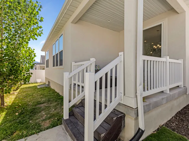 Exterior wall featuring a light-colored stucco finish and multiple windows