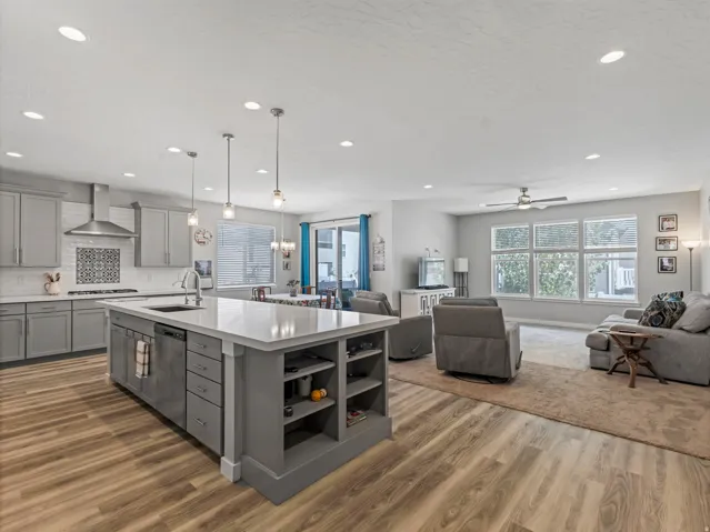 Open-concept living area featuring wood-finish flooring