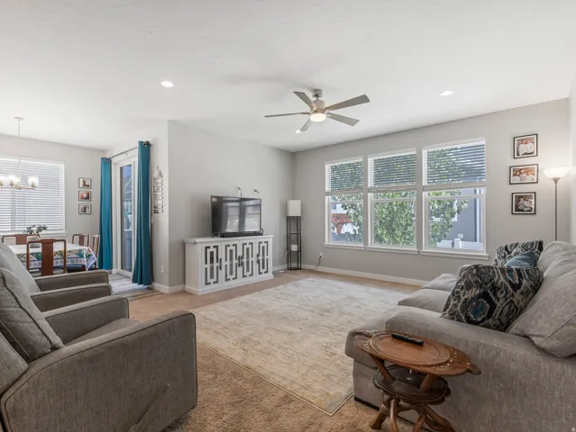 Expansive living area with neutral wall tones and carpeted flooring