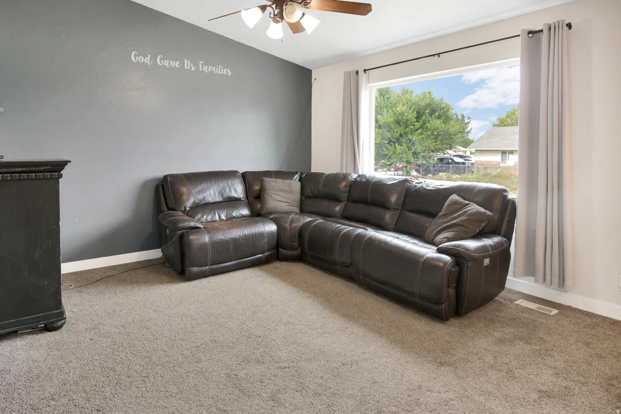 Carpeted flooring paired with a neutral wall color and a contrasting accent wall