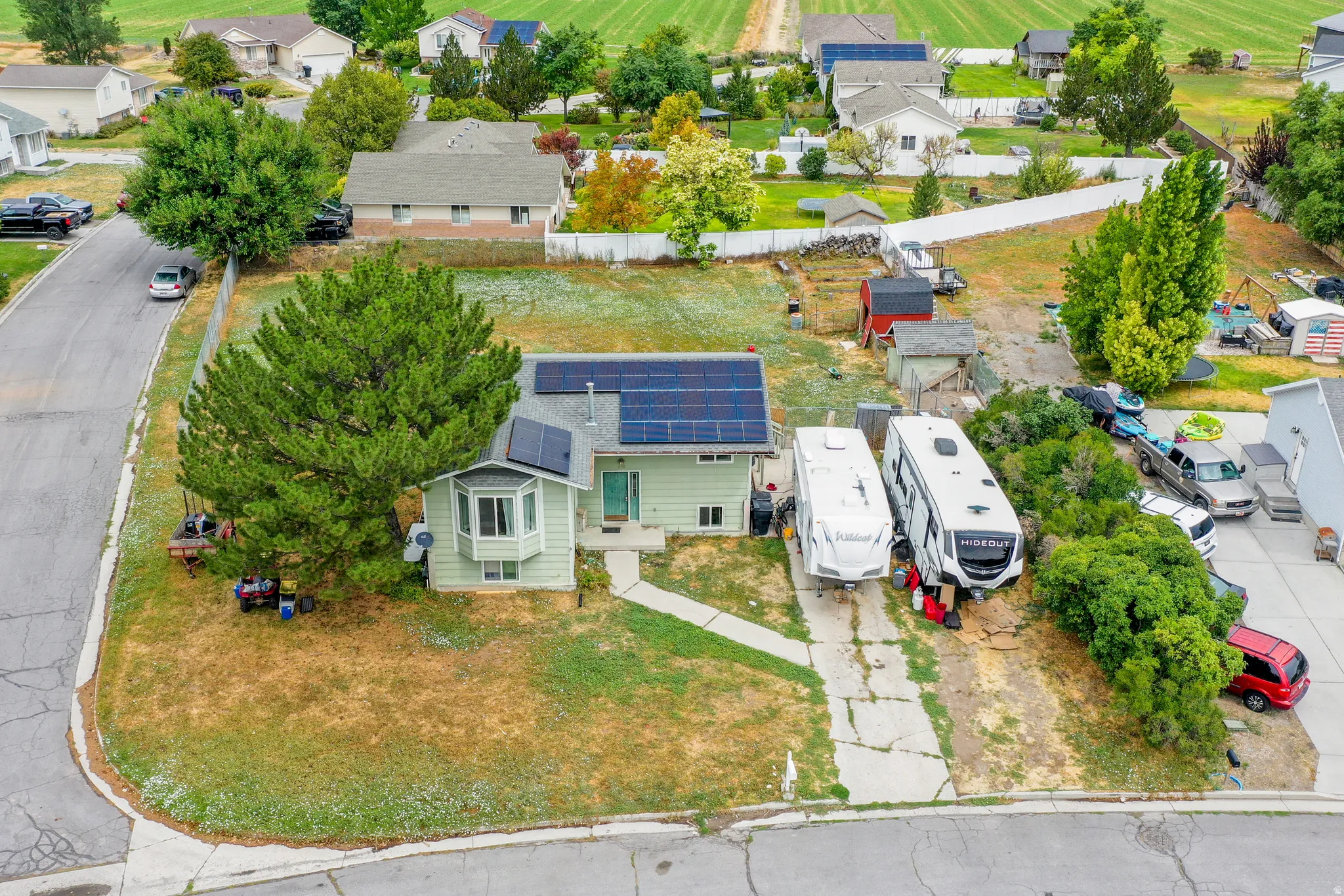 Single-story residence featuring a bay window, a concrete driveway, and a large front yard