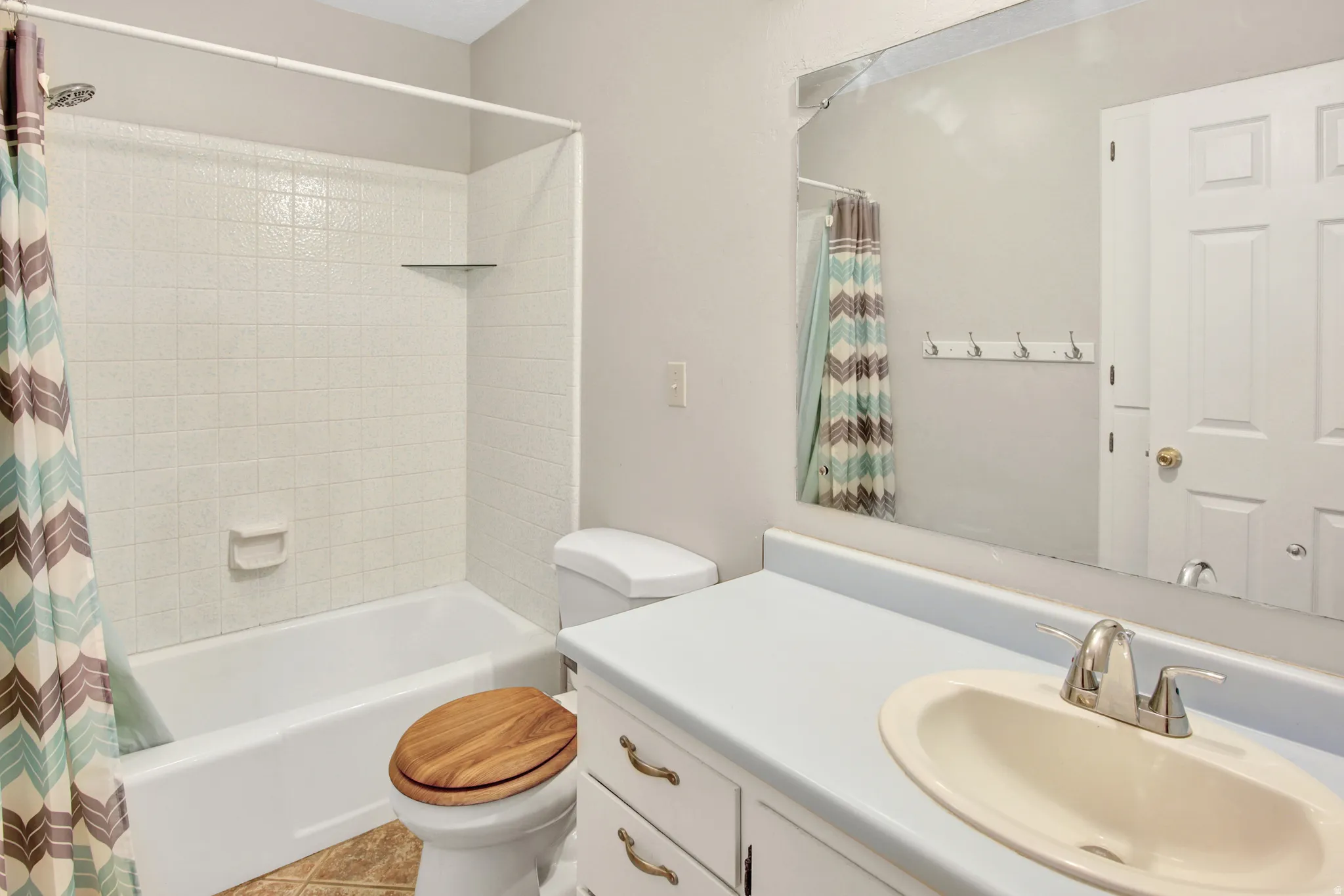White tiled shower with a built-in shelf