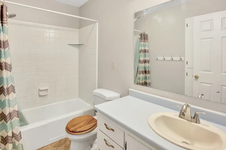 White tiled shower with a built-in shelf