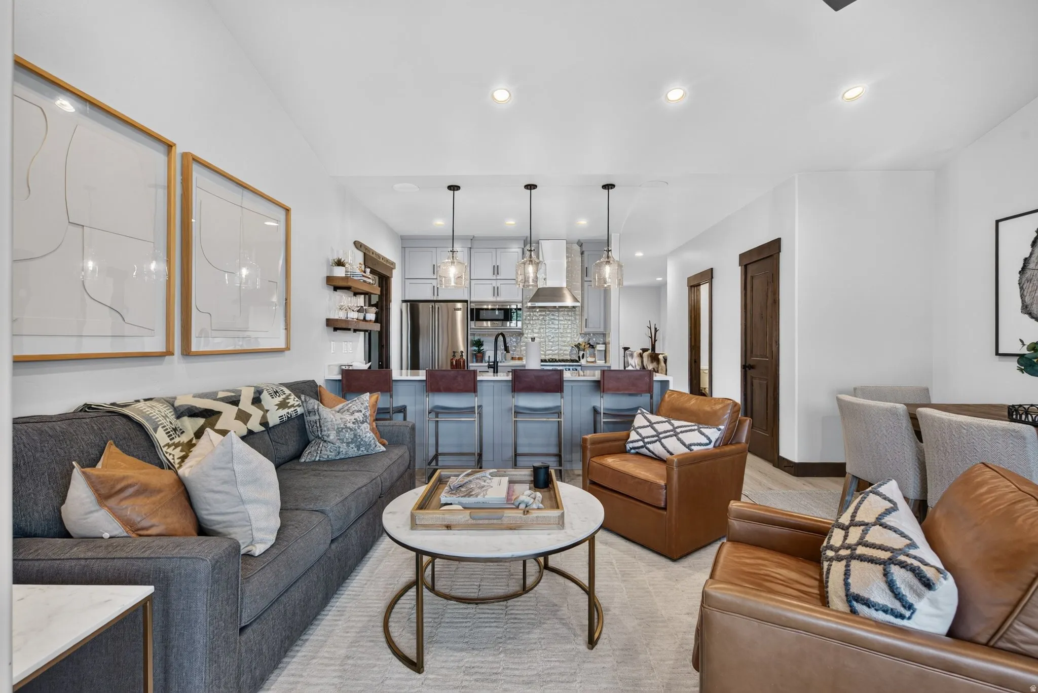 Integrated living space featuring wood-finish flooring and recessed lighting