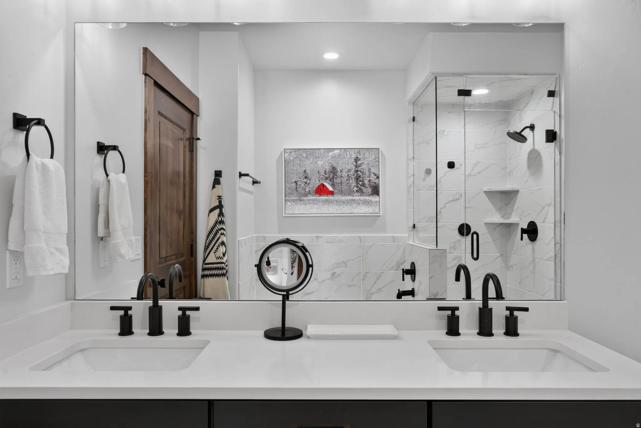 Dual vanity with integrated sinks, white countertops, and matte black fixtures