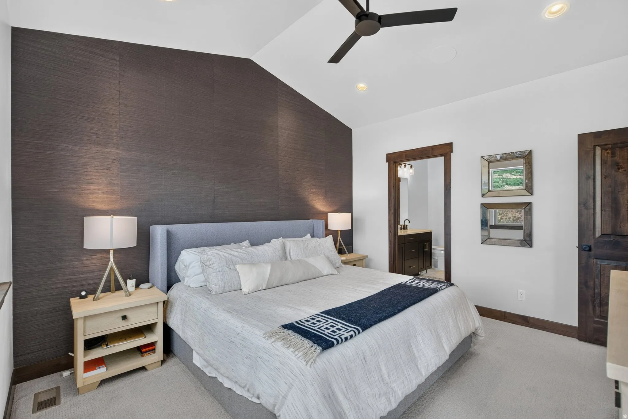 Vaulted ceiling with recessed lighting and a ceiling fan